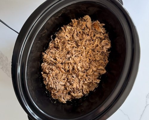 Crockpot of shredded pork tenderloin.