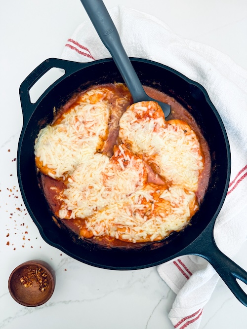 Baked chicken marinara in a cast iron skillet.