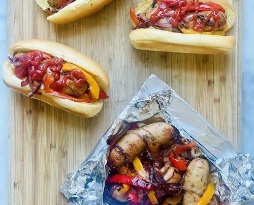 Grilled peppers and sausage in buns.