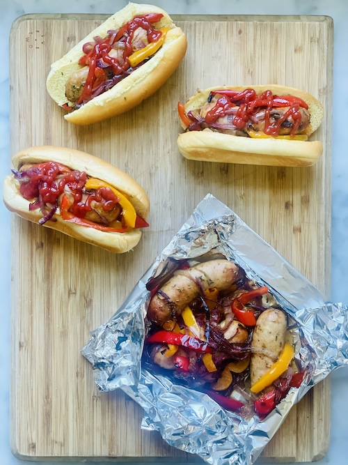 Grilled peppers and sausage in buns.