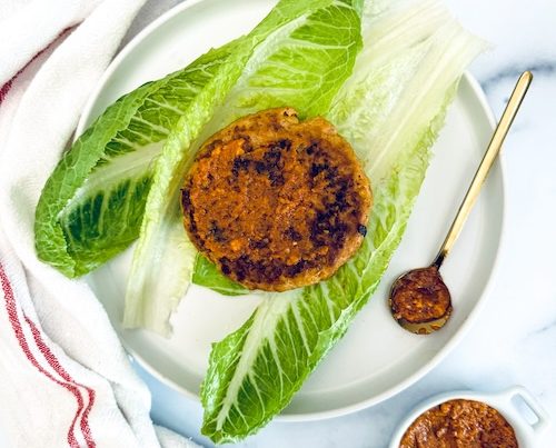 Pesto turkey burger in a lettuce wrap.