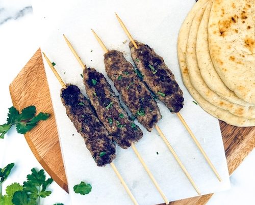 Kofta kebabs on a cutting board.