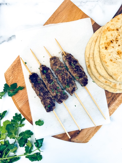 Kofta kebabs on a cutting board.