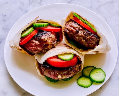 Lamb burgers in pita bread.