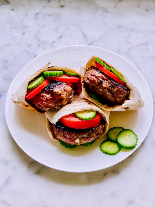 Lamb burgers in pita bread.