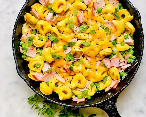 Tortellini ham bake in a cast iron skillet.