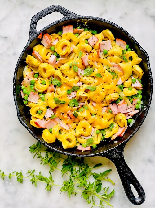 Tortellini ham bake in a cast iron skillet.
