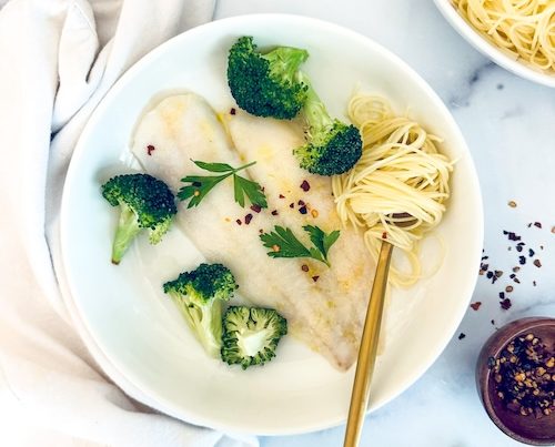 Butter-braised flounder and broccoli in a bowl.