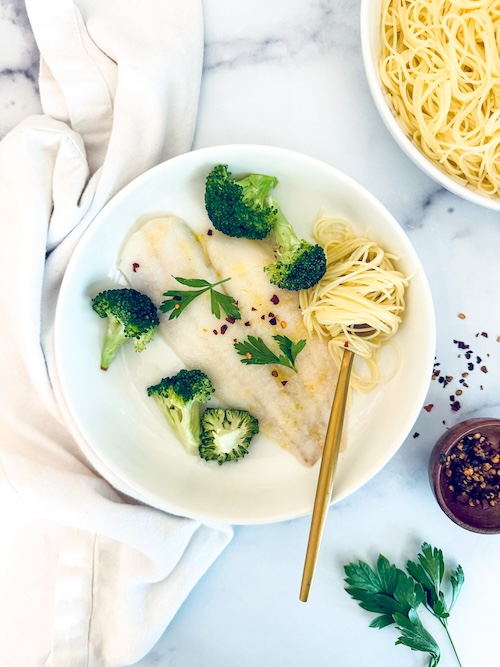 Butter-braised flounder and broccoli in a bowl.