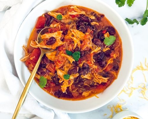 A bowl full of chicken taco chili.
