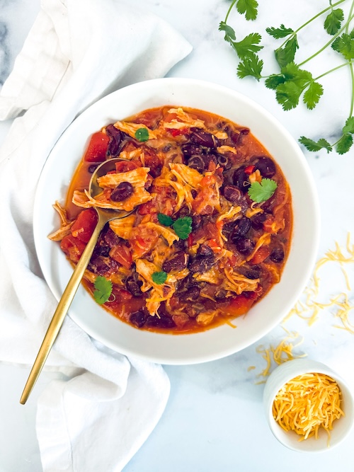 A bowl full of chicken taco chili.