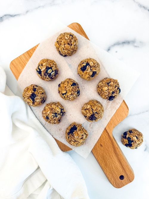 Oatmeal raisin granola bites on a cutting board.