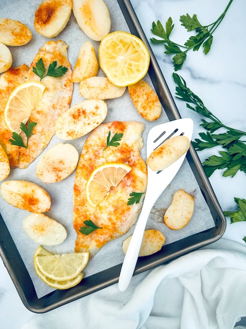 Flounder and potatoes on a sheet pan.