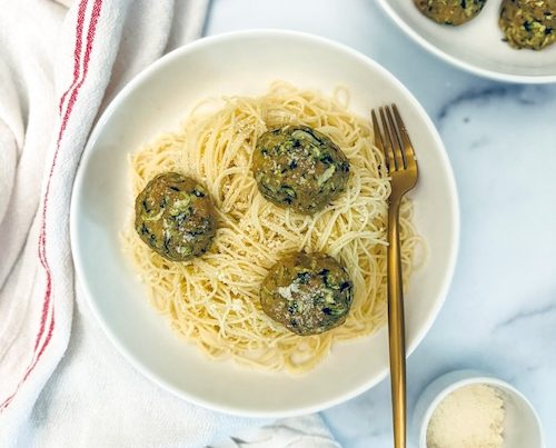 Zucchini meatballs over linguine.