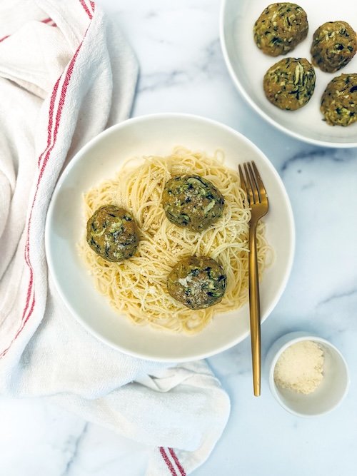 Zucchini meatballs over linguine.