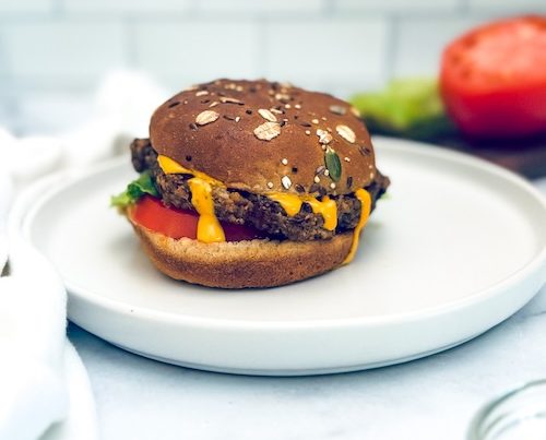 Vegan veggie burger on an oatmeal bun.
