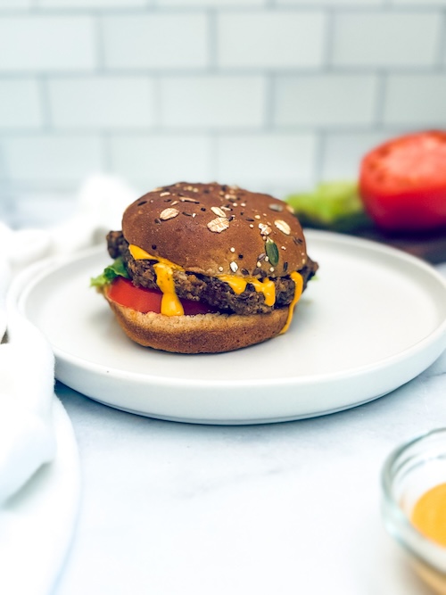 Vegan veggie burger on an oatmeal bun.