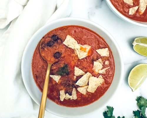 Bowls of red lentil tortilla soup.