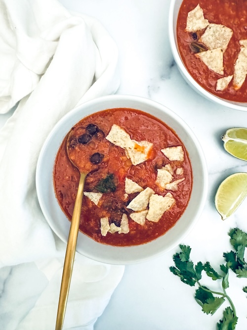 Bowls of red lentil tortilla soup.