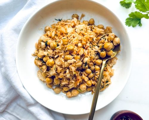 A bowl of herbed chickpeas with rice.