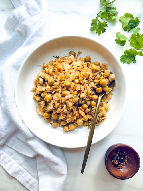 A bowl of herbed chickpeas with rice.