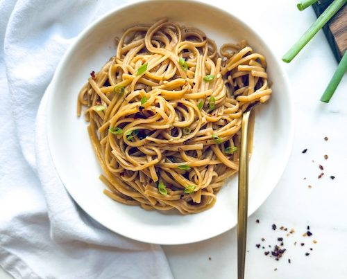 A bowl of spicy peanut butter noodles.