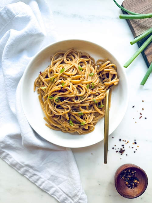 A bowl of spicy peanut butter noodles.