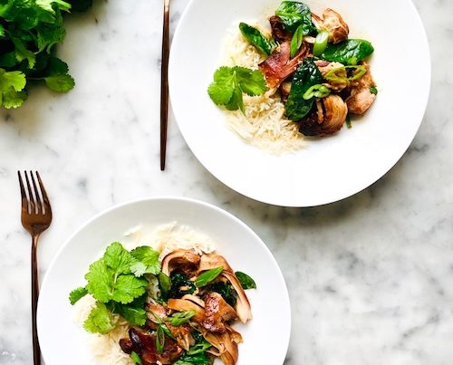 Two bowls of garlic honey chicken over rice.