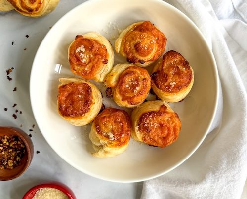 Pepperoni cheese rolls in a bowl.