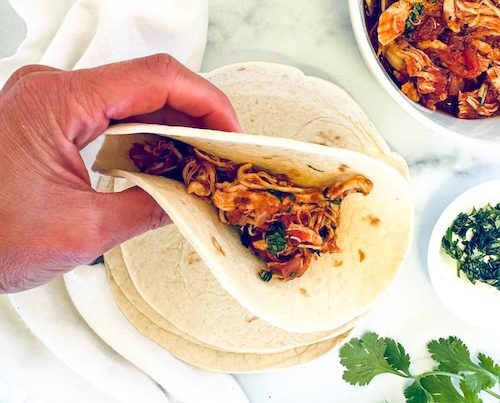 Crockpot chicken fajita in a tortilla.