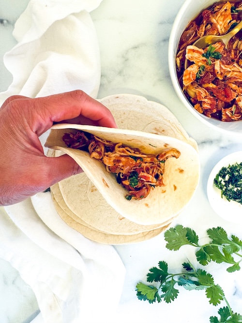 Crockpot chicken fajita in a tortilla.