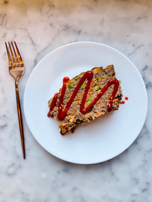 A slice of chipotle cheddar meatloaf on a plate.