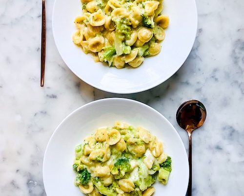 Two bowls of broccoli pasta.