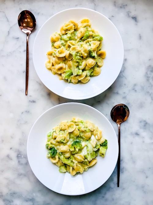 Two bowls of broccoli pasta.