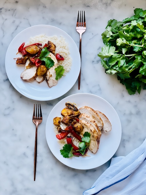 Two plates of mango jerk chicken and rice.
