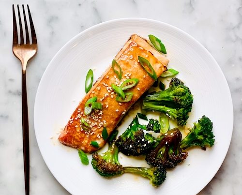 Salmon and broccoli on a plate.