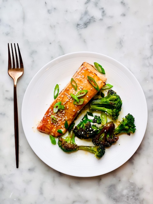 Salmon and broccoli on a plate.