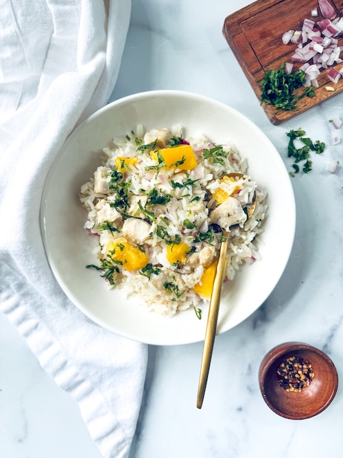 Mango chicken rice in a bowl.