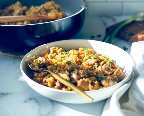 Sticky chicken and coconut rice in a bowl.