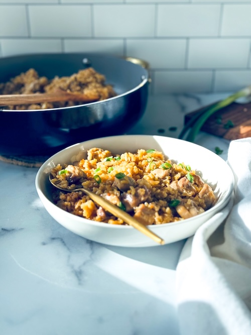 Sticky chicken and coconut rice in a bowl.