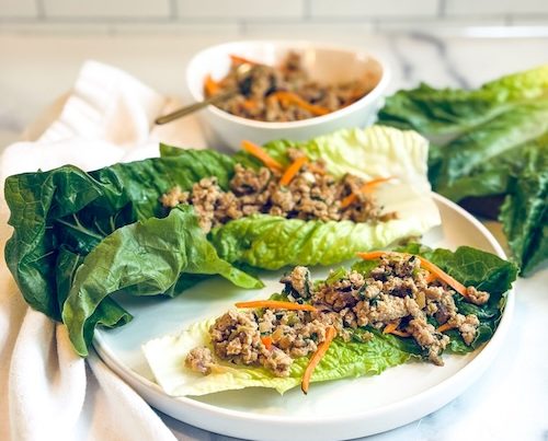 Thai chicken lettuce wraps on a plate.