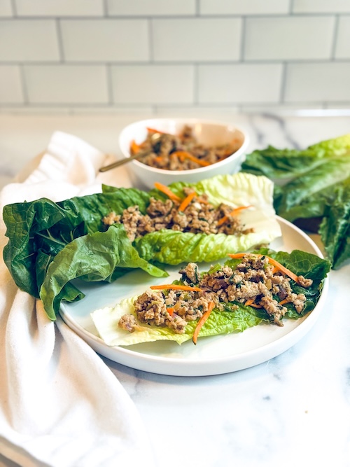 Thai chicken lettuce wraps on a plate.