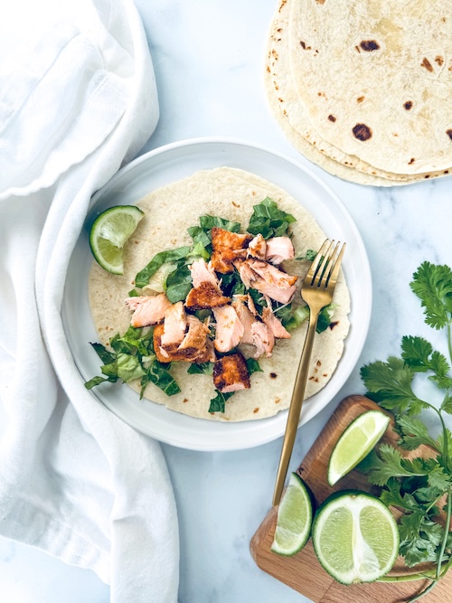 Salmon taco on a plate.