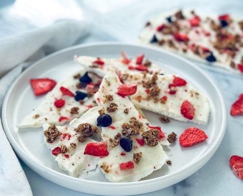 Frozen yogurt breakfast bark on a plate.