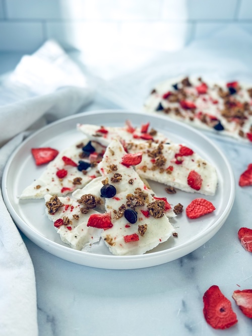 Frozen yogurt breakfast bark on a plate.
