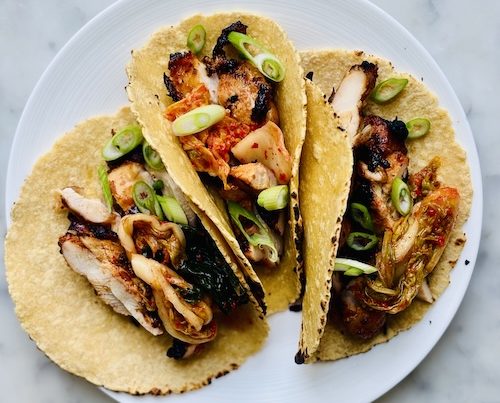 Korean chicken tacos on a plate.
