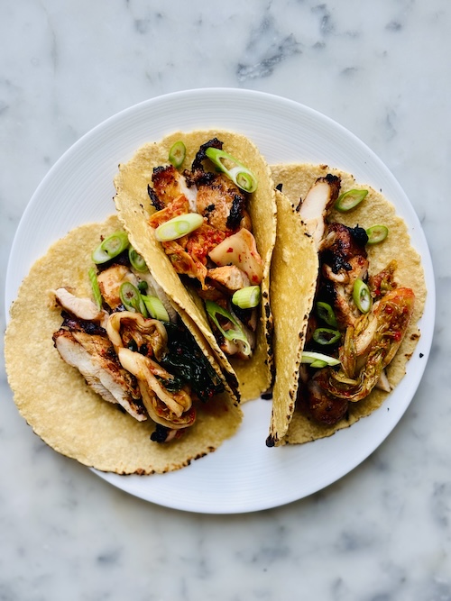 Korean chicken tacos on a plate.