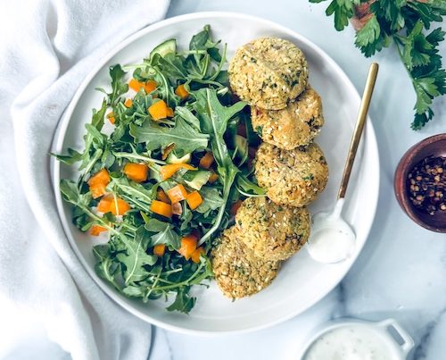Vegan falafel bites with arugula salad.