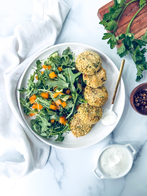 Vegan falafel bites with arugula salad.
