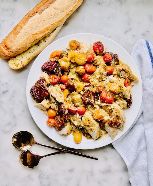 Pesto chicken and tomatoes on a plate.